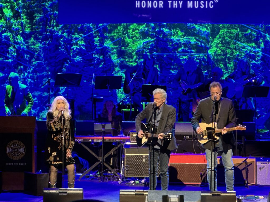 Emmylou Harris, Rodney Crowell and Vince Gill performing at the Country Music Hall of Fame's medallion ceremony in 2024; photo credit: Jewly Hight
